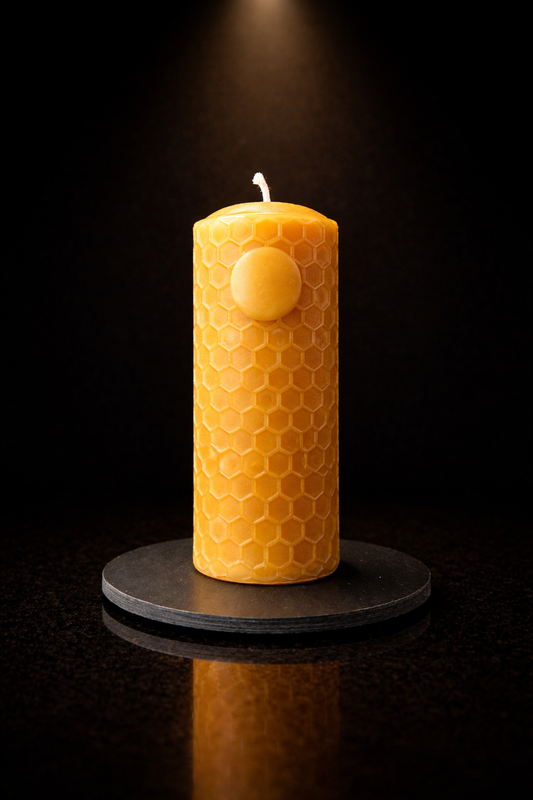 Sun beeswax candle displayed on natural slate candle plate by Ra Lumière